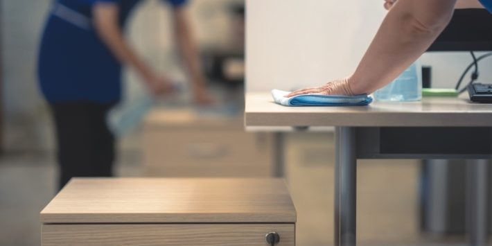 Hand,Of,The,Cleaner,Cleans,The,Office,Table.cleaning,Concept.